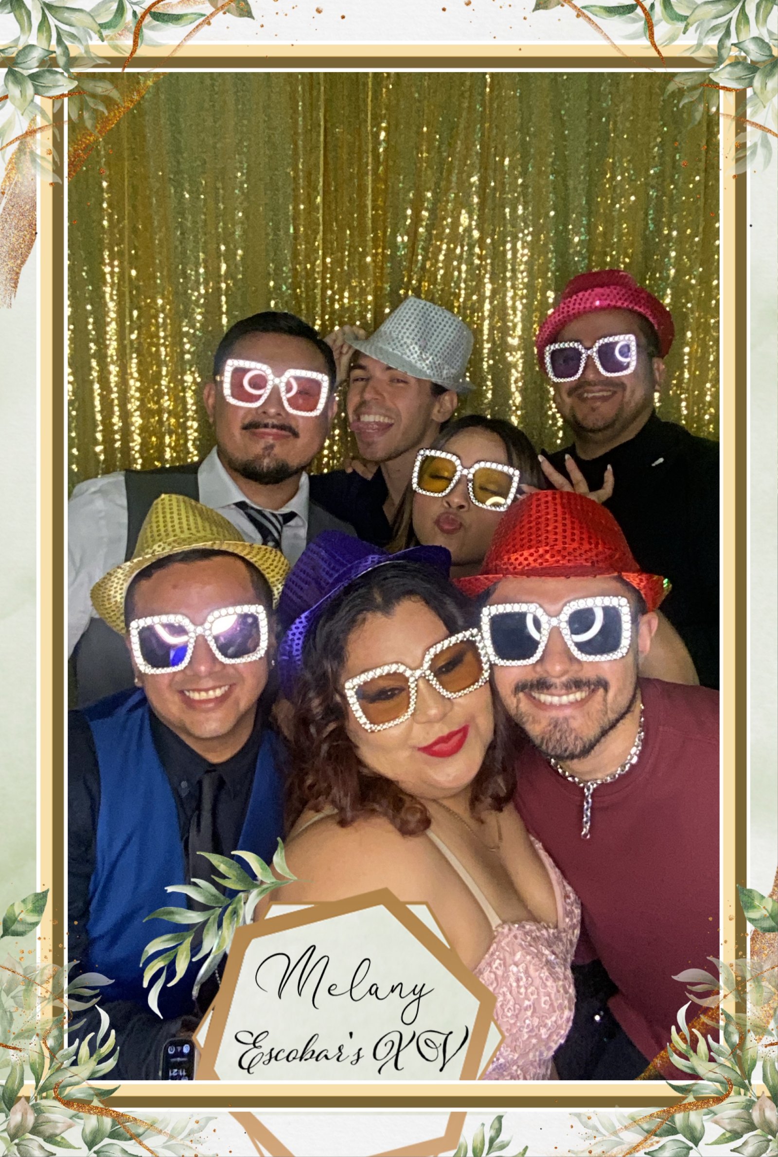 Friends using photo booth at graduation party